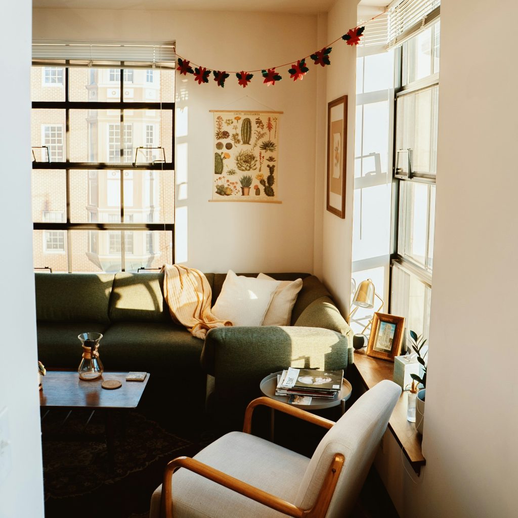 living room with a sofa, chairs, and window